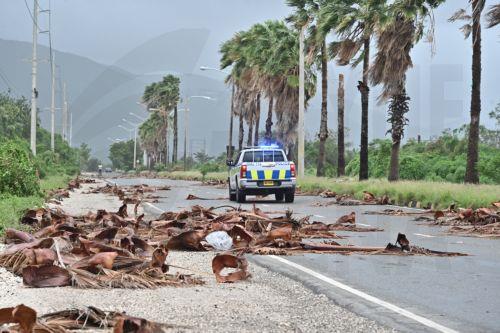 epaselect epa12488125 A police vehicle drives along a road littered with tree debris left behind by Hurricane Melissa in Kingston, Jamaica, 28 October 2025. Hurricane Melissa made landfall in Jamaica with maximum sustained winds of nearly 295 kilometers per hour (185 miles per hour), torrential rains, and storm surges that threaten to cause flooding and...
