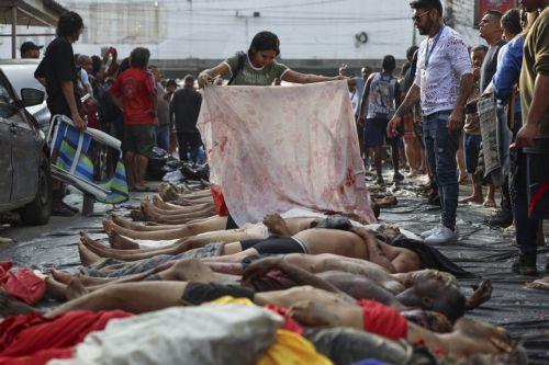 epa12490724 ATTENTION EDITORS: GRAPHIC CONTENT

People look at dead bodies on a street in Rio de Janeiro, Brazil 29 October 2025. The police operation launched on 28 October in Rio de Janeiro, the deadliest in the Brazilian city's history, left 132 people dead, including four officers, the regional Public Defender's Office told EFE.  EPA/ANDRE COELHO...