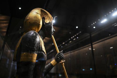 epa12502283 A gilded wooden statue of Tutankhamun is displayed at the Grand Egyptian Museum during the museum's opening to the public in Giza, Egypt, 04 November 2025. Located on the Giza Plateau, the Grand Egyptian Museum is recognized as the world's largest archaeological museum dedicated to a single culture, and is home to more than 100,000 artifacts. ...