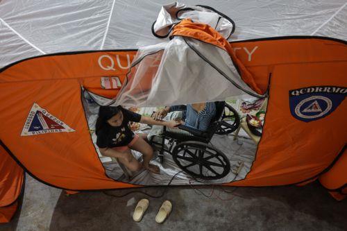 epa12513650 Residents of a flood-prone district stay inside a modular tent at an evacuation center set up in anticipation of Typhoon Fung-Wong in Quezon City, Metro Manila, Philippines, 09 November 2025. According to the Philippine Atmospheric, Geophysical, and Astronomical Services Administration (PAGASA), the typhoon is projected to be 100 kilometers...