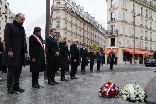 epa12522742 (L-R) President of the French victims' association Life for Paris, Arthur Denouveaux, Paris' mayor Anne Hidalgo, French President Emmanuel Macron, his wife Brigitte Macron and President of 13onze15 Fraternite et Verite association Philippe Duperron attend a ceremony in tribute to the victims at the intersection of Rue Alibert and Rue Bichat,...