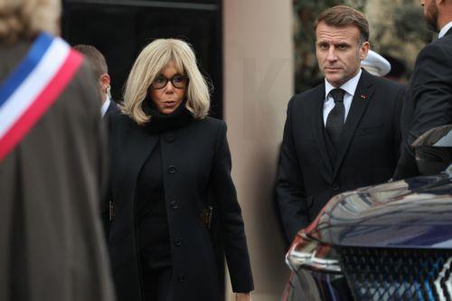 epa12522860 French President Emmanuel Macron (R) and his wife Brigitte Macron (L) walk at the intersection of Rue Alibert and Rue Bichat, near Le Carillon and Le Petit Cambodge, two of the sites targeted in the November 2015 Paris attacks, during a ceremony in tribute to the victims, in Paris, France, 13 November 2025. Ten years ago 130 people were killed,...