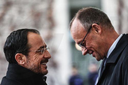 epa12525685 German Chancellor Friedrich Merz (R) greets the Cypriot President Nikos Christodoulides (L) with military honours, at the Federal Chancellery of Germany in Berlin, Germany, 14 November 2025. Christodoulides' visit aims to present to Merz the main pillars of Cyprus's EU presidency program, including EU defense, border management, and support for...