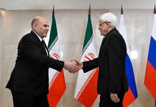 epa12531411 Russian Prime Minister Mikhail Mishustin (L) and Iranian First Vice President Mohammad Reza Aref shake hands before a meeting on the sidelines of the 24th meeting of the Council of Heads of Government of member states of the Shanghai Cooperation Organization (SCO), in Moscow, Russia, 17 November 2025.  EPA/ALEXANDER MIRIDONOV / SPUTNIK /...