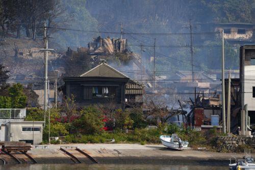 epa12534907 Smoke rises from the site of a fire that burned residential buildings and shops Saganoseki district of Oita, southwestern Japan, 19 November 2025. A fire broke out in the Saganoseki district on the evening of 18 November 2025, damaging more than 170 buildings. According to Oita Prefecture government, a man in his 70s is unaccounted for while 175...