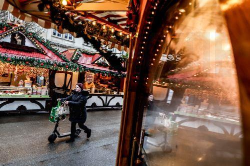 epa12537571 A visitor pushes a scooter as she walks at the Christmas Market in Magdeburg, Germany, 20 November 2025. The market opened under enhanced protective measures nearly a year after a man drove a car through the market on 20 December 2024, killing six people and injuring over 300.  EPA/FILIP SINGER