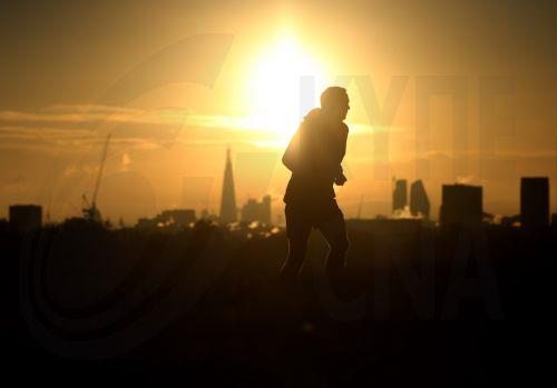 epa12539682 A jogger runs as the sun rises over Primrose Hill in London, Britain, 21 November 2025. Winter weather continues across the UK, with temperatures falling below zero overnight. The Met Office has described the conditions as the 'first notable cold snap of this autumn,' bringing 'wintry hazards' and prompting the agency to issue warnings for snow...