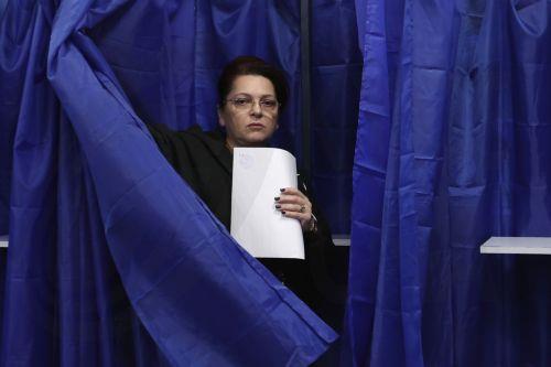 epa12576438 A Romanian woman exits the voting booth holding her ballot during the capital's mayoral elections at a polling station in Bucharest, Romania, 07 December 2025. The Romanian capital, Bucharest, holds its early mayoral elections on 07 December, following Nicusor Dan's ascent from mayor to President of Romania earlier this year.  EPA/ROBERT GHEMENT