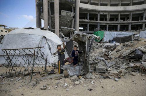 epa12578945 Internally displaced Palestinian boys play outside their family tent set up among the ruins of destroyed buildings in the Al Sheikh Radwan neighborhood of Gaza City, Gaza Strip, 08 December 2025, amid a ceasefire between Israel and Hamas. Around 1.9 million people in Gaza, nearly 90 percent of the population, have been displaced since the...