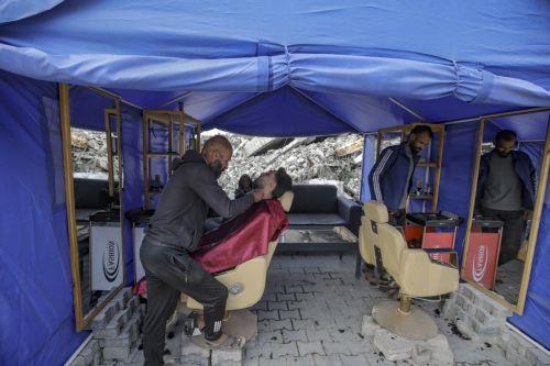 epa12578946 Palestinians get a haircut at a makeshift tent set up near the ruins of destroyed buildings in the Al Sheikh Radwan neighborhood of Gaza City, Gaza Strip, 08 December 2025, amid a ceasefire between Israel and Hamas. Around 1.9 million people in Gaza, nearly 90 percent of the population, have been displaced since the Israel-Hamas conflict began...