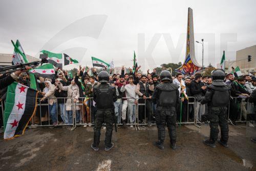 epa12578984 People watch as Syrian army soldiers march during a parade marking the first anniversary of the ousting of the Bashar Al-Assad regime in Damascus, Syria, 08 December 2025. Syria marks the first anniversary of the overthrow of the Assad regime on 08 December when the dictatorship of Bashar al-Assad collapsed during a major offensive by opposition...