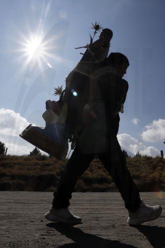 epa12581903 A person carries a religious image during a pilgrimage to the Basilica of Guadalupe in Paso de Cortes mountain pass in Puebla state, Mexico, 09 December 2025. Hundreds of Mexican faithful began their annual pilgrimage to the Shrine of the Virgin of Guadalupe this week, which is expected to draw millions of visitors marking the 494th anniversary...