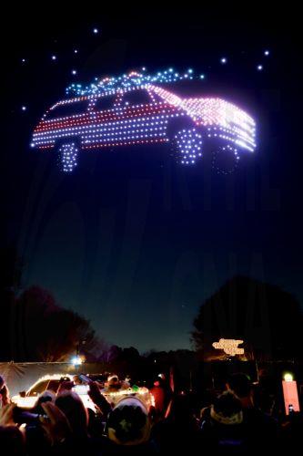 epa12582012 Crowds watch a 1987 Chevrolet Suburban created by drones during a sponsored Christmas holiday display at Piedmont Park in Atlanta, Georgia, USA, 09 December 2025. The show 'Chevy Holiday Magic', sponsored by automobile manufacturer Chevrolet, featured 1,000 choreographed drones.  EPA/ERIK S. LESSER