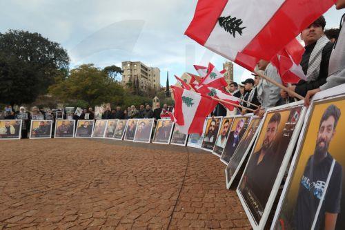 epa12587532 Activists and relatives of detainees in Israeli prisons carry pictures of the Lebanese prisoners in Israeli jails, during a protest outside the United Nations Economic and Social Commission for Western Asia (UN-ESCWA) headquarters in Beirut, Lebanon, 12 December 2025. Activists and relatives of detainees in Israeli prisons gather for a protest...