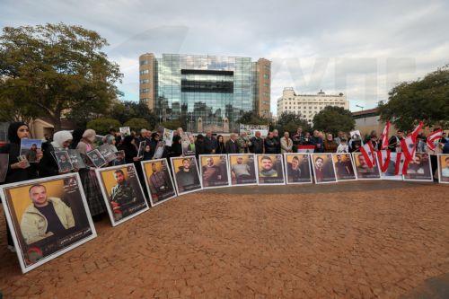 epa12587534 Activists and relatives of detainees in Israeli prisons carry pictures of the Lebanese prisoners in Israeli jails, during a protest outside the United Nations Economic and Social Commission for Western Asia (UN-ESCWA) headquarters in Beirut, Lebanon, 12 December 2025. Activists and relatives of detainees in Israeli prisons gather for a protest...