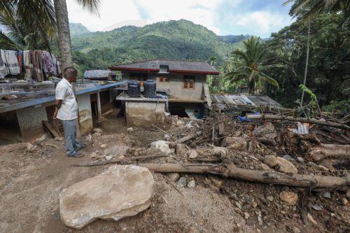 epa12587676 A landslide victim stands near his damaged house after landslides in Badulla, Sri Lanka, 12 December 2025. Many parts of the island had been inundated, and there had been many landslides due to Cyclone Ditwah. According to the Sri Lanka Disaster Management Center, More than 630 people have been killed, and 193 are missing around the country in...
