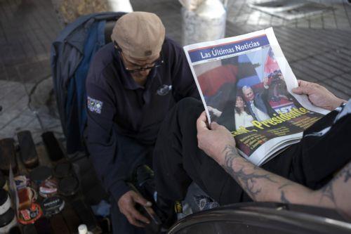 epa12594400 A man reads a newspaper announcing the results of the presidential elections in Santiago, Chile, 15 December 2025. The far-right Jose Antonio Kast won the second round of the presidential elections in Chile on 14 December.  EPA/ADRIANA THOMASA