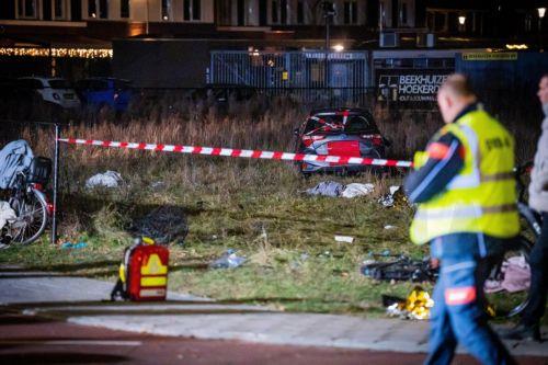 epa12609346 Emergency services work at the scene of an accident on the Elburgerweg in Nunspeet, the Netherlands, 22 December 2025. According to police, a car drove into a group of people injuring at least nine people, including three with serious wounds.  EPA/ROLAND HEITINK