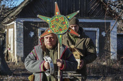 epa12612273 A handout photo made available by the press service of the 33rd Separate Mechanized Brigade of Ukrainian Armed Forces shows servicemen of the 33rd Separate Mechanized Brigade celebrating Christmas at their position on a frontline in Donetsk region, Ukraine, 25 December 2025, amid the ongoing Russian invasion. Ukraine celebrates Christmas on 25...
