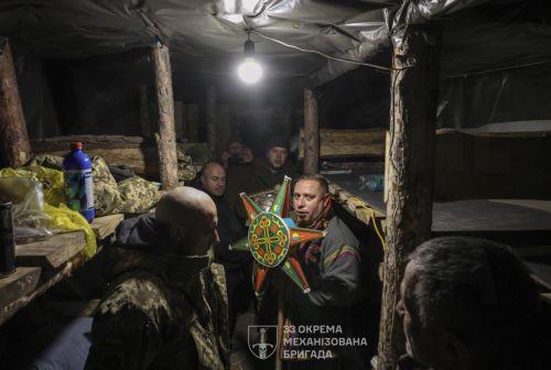 epa12612277 A handout photo made available by the press service of the 33rd Separate Mechanized Brigade of Ukrainian Armed Forces shows servicemen of the 33rd Separate Mechanized Brigade celebrating Christmas at their position on a frontline in Donetsk region, Ukraine, 25 December 2025, amid the ongoing Russian invasion. Ukraine celebrates Christmas on 25...
