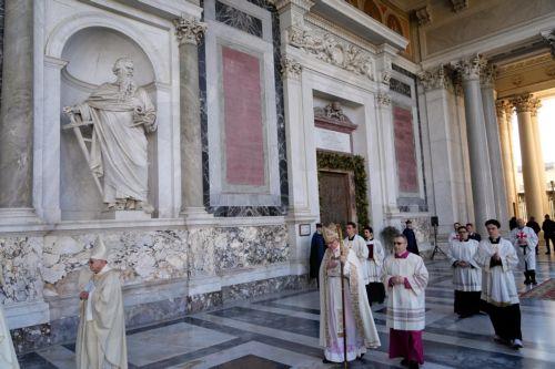 epa12615217 Cardinal James Michael Harvey, archpriest of the Papal Basilica of St. Paul Outside the Walls (C), walks past the closed basilica’s Holy Door during a ceremony in Rome, Italy, 28 December 2025. The rite marks one of the final ceremonial closures of Holy Doors across the city's major papal basilicas ahead of the formal conclusion of the Catholic...