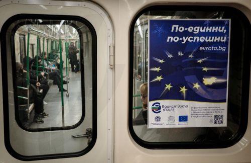 epa12616778 People ride the subway past a euro adoption poster in Sofia, Bulgaria, 29 December 2025. Bulgaria is set to become the 21st member of the eurozone on 01 January 2026, transitioning from the national lev to the euro amid public concerns that the move could trigger immediate price hikes and a higher cost of living.  EPA/BORISLAV TROSHEV