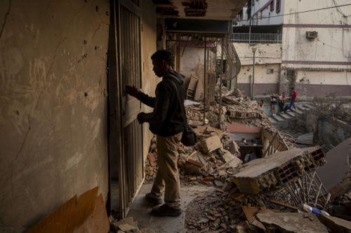 epa12627775 A person looks at a building damaged by an explosive device, in Catia La Mar, Venezuela, 04 January 2026.  EPA/MIGUEL GUTIÉRREZ