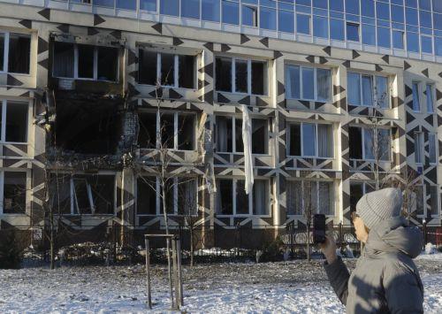 epa12628348 A woman stands near the site of a Russian drone strike on a private medical clinic in Kyiv, Ukraine, 05 January 2026, amid the Russian invasion. At least one person was killed and three others were injured as a result of the attack, according to the State Emergency Service of Ukraine.  EPA/SERGEY DOLZHENKO