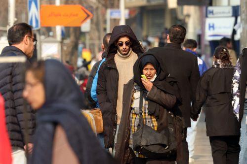 epa12635824 Iranians walk on a street in Tehran, Iran, 08 January 2026. Following a sharp decline in the national currency and soaring prices for basic goods, the country is facing a wave of nationwide anti-government protests which has spread to 37 cities across 24 provinces, according to the Human Rights Activists News Agency (HRANA).  EPA/ABEDIN...