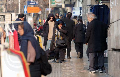 epa12635825 Iranians walk on a street in Tehran, Iran, 08 January 2026. Following a sharp decline in the national currency and soaring prices for basic goods, the country is facing a wave of nationwide anti-government protests which has spread to 37 cities across 24 provinces, according to the Human Rights Activists News Agency (HRANA).  EPA/ABEDIN...