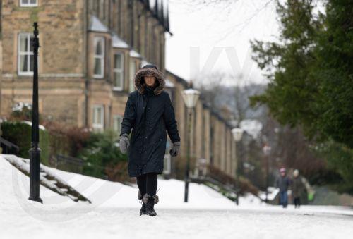 epa12637955 A person walks through snow in the Pavilion Gardens in Buxton, Britain, 09 January 2026. Met Office yellow and amber warnings for ice, snow and wind remain in force across much of Britain after Storm Goretti, the first named storm of the year, brought heavy snowfall and strong winds.  EPA/ADAM VAUGHAN