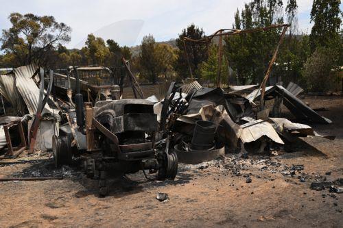 epa12639603 Destroyed tractors and sheds are seen at a property following a bushfire in Harcourt, Victoria, Australia, 10 January 2026.  EPA/JAMES ROSS EDITORIAL USE ONLY AUSTRALIA AND NEW ZEALAND OUT