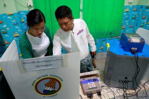 epaselect epa12639795 A volunteer and an officer of the Union Election Commission (UEC) set up an electronic voting machine at a polling station, one day ahead of the second phase of election in Yangon, Myanmar, 10 January 2026. Myanmar's military government, known as the State Administration Council (SAC), plans to hold its first national vote since the...