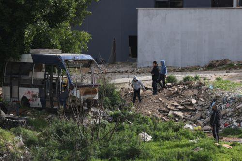epa12644868 Palestinians watch Israeli army bulldozers during a military operation in Nur Shams refugee camp, near the West Bank city of Tulkarem, 12 January 2026. Israeli troops continue their operation in the Nur Shams refugee camp, east of Tulkarem, which has been under a tight Israeli siege since January 2025.  EPA/ALAA BADARNEH