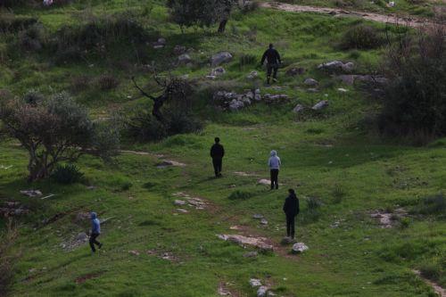 epa12644870 Palestinians watch Israeli army bulldozers during a military operation in Nur Shams refugee camp, near the West Bank city of Tulkarem, 12 January 2026. Israeli troops continue their operation in the Nur Shams refugee camp, east of Tulkarem, which has been under a tight Israeli siege since January 2025.  EPA/ALAA BADARNEH