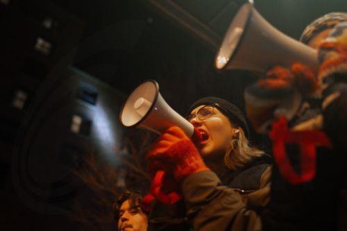 epa12647875 Protesters shout into bullhorns during a protest outside a Hilton hotel thought to house federal immigration enforcement agents in Minneapolis, Minnesota, USA, 13 January 2026. As part of a federal immigration crackdown involving over 2,000 agents from Border Patrol, Immigration and Customs Enforcement (ICE), and Homeland Security Investigations...