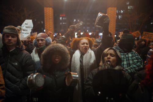epa12647877 Protesters make noise and hold anti-ICE signs outside a Hilton hotel thought to house federal agents in Minneapolis, Minnesota, USA, 13 January 2026. As part of a federal immigration crackdown involving over 2,000 agents from Border Patrol, Immigration and Customs Enforcement (ICE), and Homeland Security Investigations (HSI), an ICE officer...