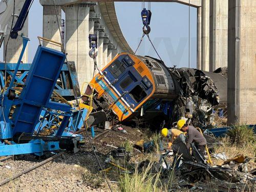 epa12648016 Workers search the wreckage of a passenger train after a construction crane collapsed onto it in Sikhio district, Nakhon Ratchasima, Thailand, 14 January 2026. At least 22 people were killed and more than 79 others injured when the crane fell on the Special Express No. 21 train traveling from Bangkok to Ubon Ratchathani, according to local...