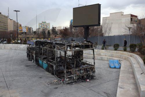 epa12650616 The wreckage of a burnt-out public bus in Tehran, Iran, 15 January 2026. The country remains under a near-total nationwide internet blackout that began on 08 January, amid an intensifying wave of anti-government protests.  EPA/ABEDIN TAHERKENAREH