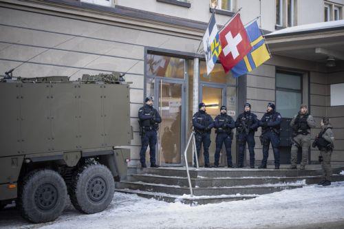 epa12653773 Members of the police and army stand guard outside the district council chamber during a press conference of police and army regarding security prior the 56th annual meeting of the World Economic Forum (WEF) in Davos, Switzerland, 16 January 2026. The meeting, under the theme 'A Spirit of Dialogue,' brings together entrepreneurs, scientists,...