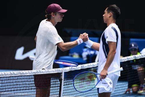 epa12660312 Alex de Minaur (L) of Australia shakes hands with opponent Mackenzie McDonald (R) of the USA after winning their men’s first round match on day 2 of the 2026 Australian Open tennis tournament at Melbourne Park in Melbourne, Australia, 19 January 2026.  EPA/JOEL CARRETT AUSTRALIA AND NEW ZEALAND OUT