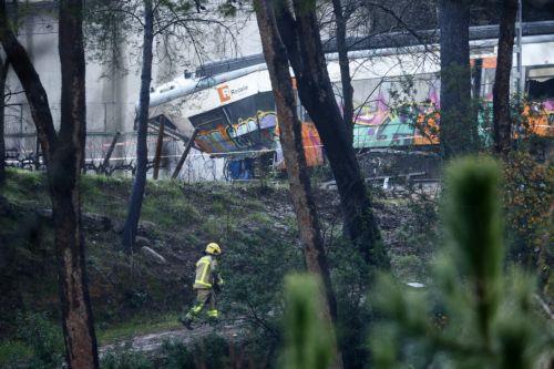 epa12666729 A commuter train that derailed between Gelida and Sant Sadurni d'Anoia, Barcelona, Spain, 21 January 2026. The train driver has died and 37 passengers were injured, four of them seriously, after the train crashed into a collapsed retaining wall late 20 January.  EPA/QUIQUE GARCIA