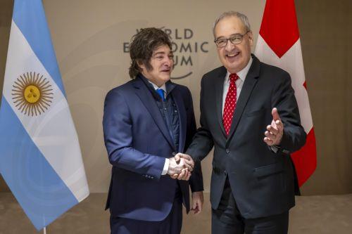 epa12666885 Argentina's President Javier Milei (L) shakes hands with Switzerland's Federal President Guy Parmelin (R) prior to a bilateral meeting on the sideline of the 56th annual meeting of the World Economic Forum (WEF) in Davos, Switzerland, 21 January 2026. The meeting under the topic 'A Spirit of Dialogue' brings together entrepreneurs, scientists,...