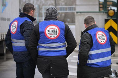 epa12682815 Protesting truck drivers stand near their vehicles at the Serbia-Hungary border during a blockade of the cargo line at the Horgos border crossing in northern Serbia, 26 January 2026. All border crossings in the country and the wider region are blocked to freight traffic starting 26 January at noon, following a coordinated protest by truck...