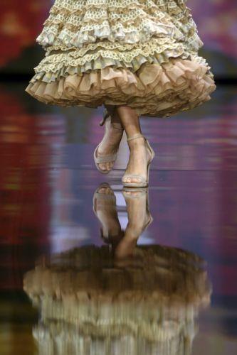 epa12690210 A model takes to the catwalk with some creations by Huelva's region designers under the motto 'Flamenco by Nature' during the International Flamenco Fashion Week held in Seville, Spain, on 29 January 2026.  EPA/Raul Caro