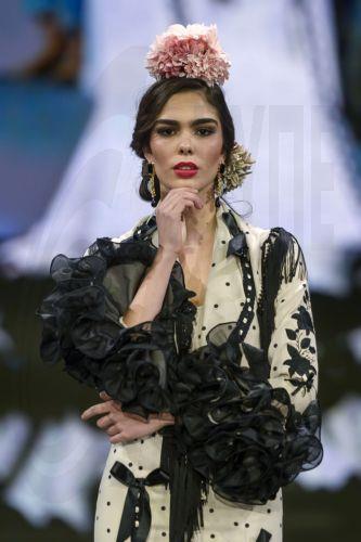epa12690215 A model takes to the catwalk with some creations by Huelva's region designers under the motto 'Flamenco by Nature' during the International Flamenco Fashion Week held in Seville, Spain, on 29 January 2026.  EPA/Raul Caro