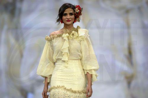 epa12690216 A model takes to the catwalk with some creations by Huelva's region designers under the motto 'Flamenco by Nature' during the International Flamenco Fashion Week held in Seville, Spain, on 29 January 2026.  EPA/Raul Caro