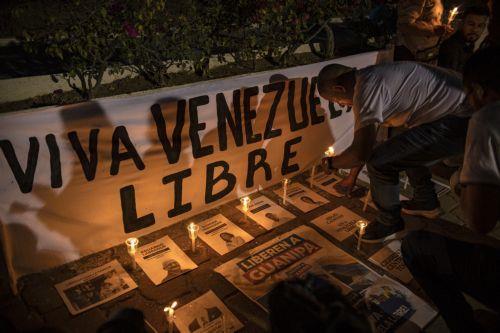 epa12699525 A person lights a candle during a vigil for the freedom of political prisoners in Plaza de la Republica, Maracaibo, Venezuela, 01 February 2026.  EPA/Henry Chirinos