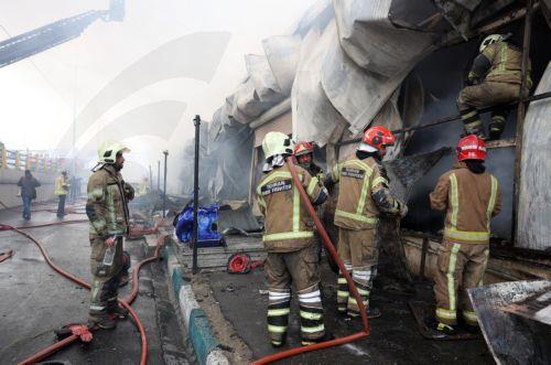epa12701672 Firefighters try to control the fire at the Jannat shopping market in western Tehran, Iran, 03 February 2026. The cause of the fire is unclear.  EPA/ABEDIN TAHERKENAREH