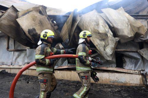 epa12701673 Firefighters try to control the fire at the Jannat shopping market in western Tehran, Iran, 03 February 2026. The cause of the fire is unclear.  EPA/ABEDIN TAHERKENAREH